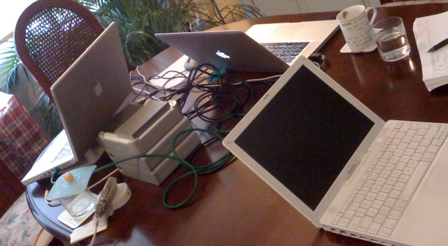 Image of laptops and hard-drives in temporary office space during an emergency